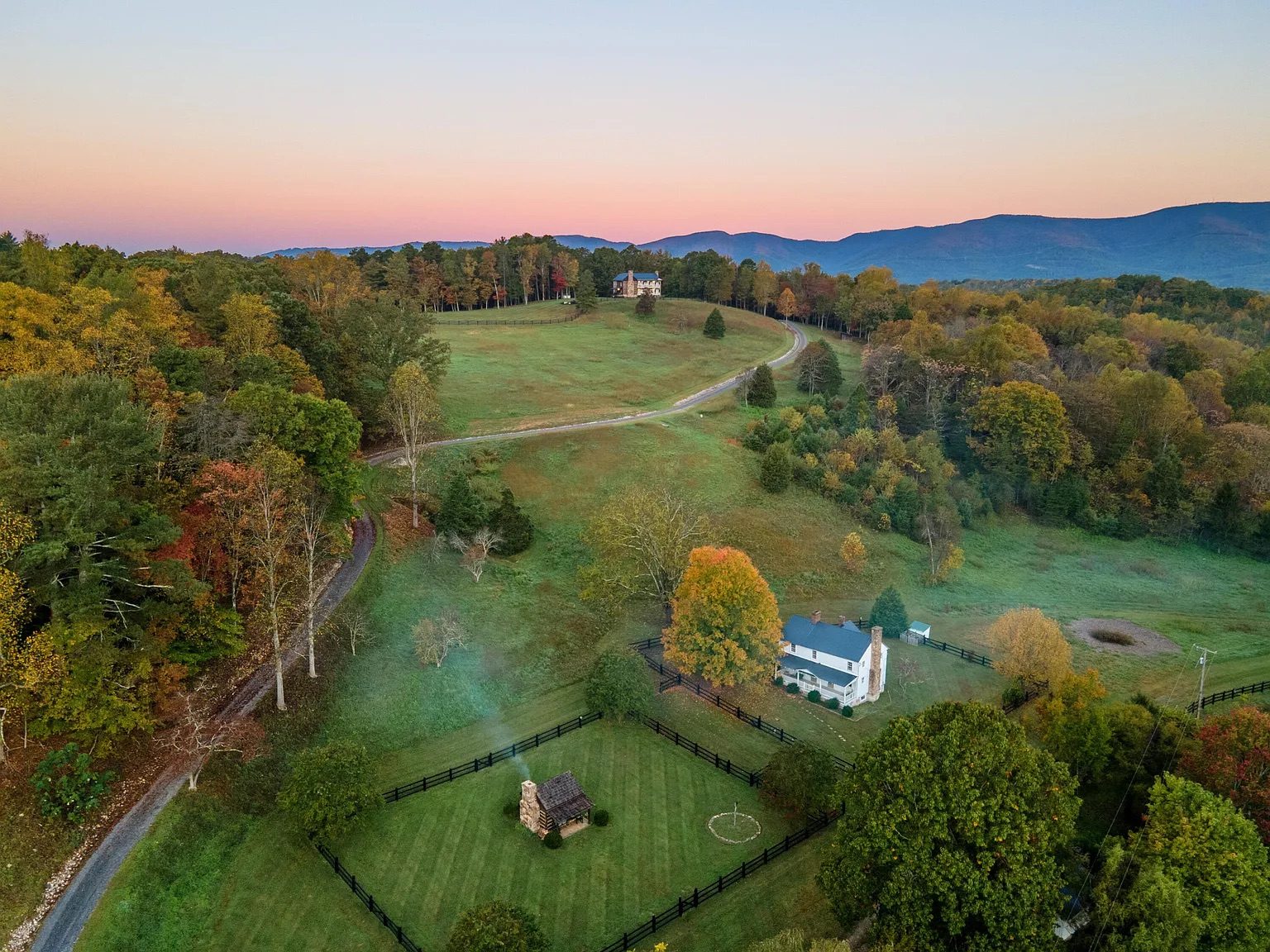 Aerial view of Harborwood Farm at sunset with the Blue Ridge mountains behind it