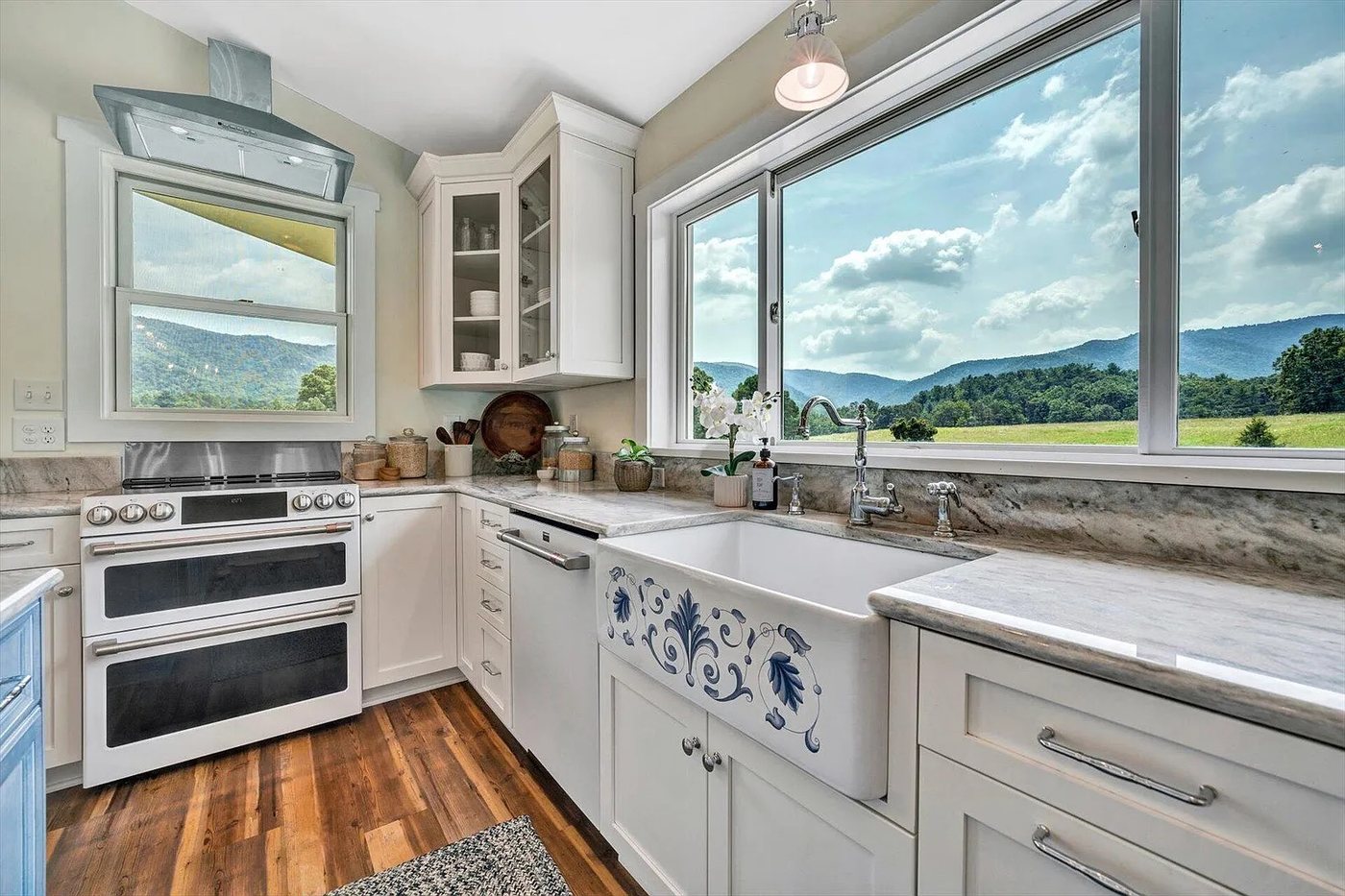Guest house kitchen with a farmhouse sink and a picture window looking out on the Blue Ridge mountains